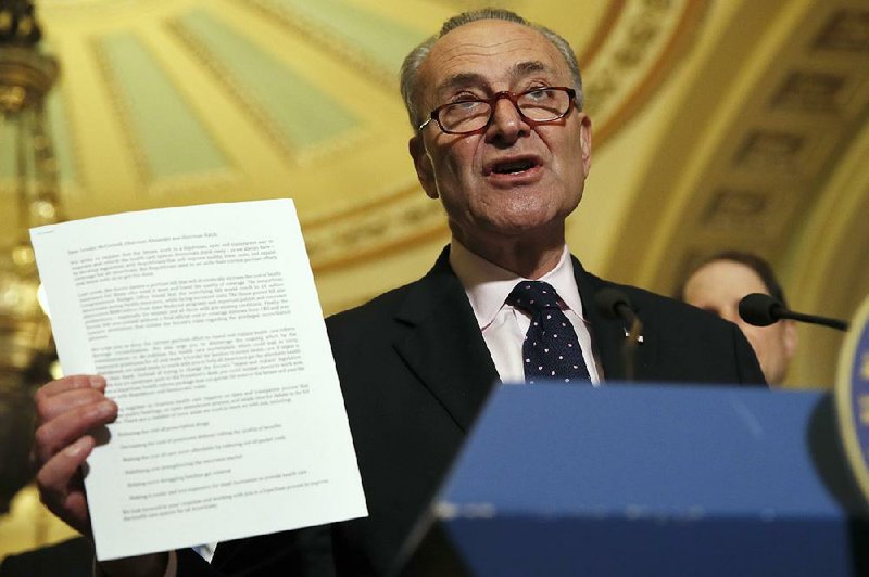 Senate Minority Leader Charles Schumer displays a letter from Senate Democrats urging their Republican colleagues to join in working on a bipartisan health care overhaul bill. Saying the House bill “is so discriminatory against women,” Schumer called it “a very, very bad thing” to exclude women from the group of GOP senators crafting a bill. Senate Majority Leader Mitch McConnell dismissed the criticism and said all 52 Republican senators were shaping the plan.