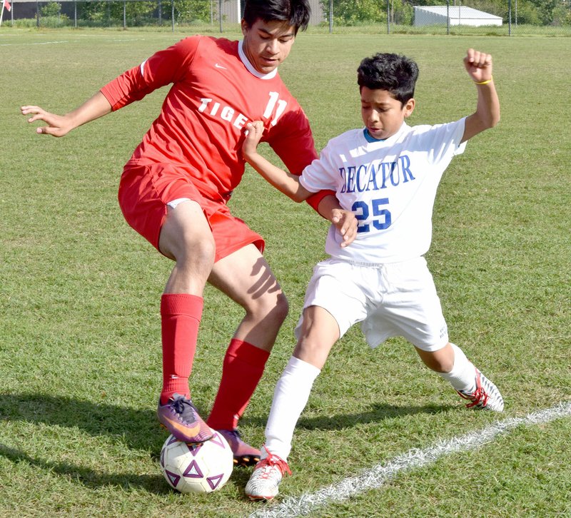 Photo by Mike Eckels Kelvin Moreno (Decatur 25) fought for control of the ball with a Green Forest player during the Decatur-Green Forest soccer match at Bulldog Stadium in Decatur May 4. Green Forest took the win, 9-0.