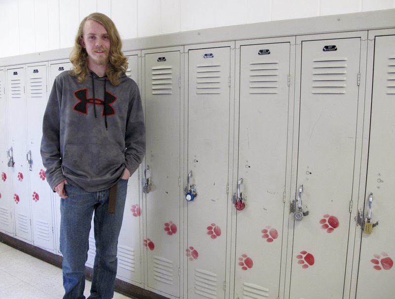 High school senior Uriah Birchmier poses in front of lockers at Helena High School in Helena, Mont., Wednesday, May 3, 2017. Birchmier participates in Upward Bound, a college preparation program for poor students and those with families that have never had a member graduate from college.