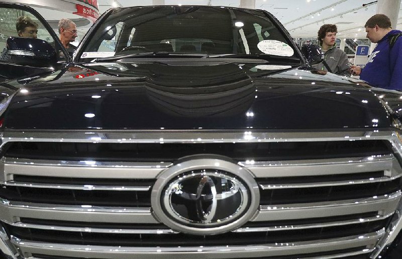 A Toyota Land Cruiser sits Wednesday in a showroom in Tokyo. Toyota expects to sell 10.2 million vehicles in the current fiscal year.
