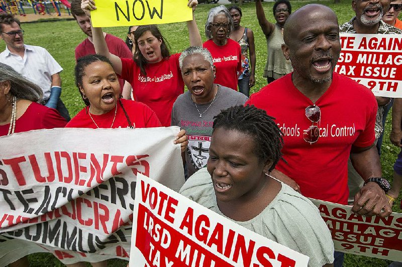 Opponents of the Little Rock School District millage extension, including Anika Whitfield (left), Vincent Tolliver (right) and Vicki Hatter (bottom), rally Wednesday in a park near Martin Luther King Jr. Elementary.