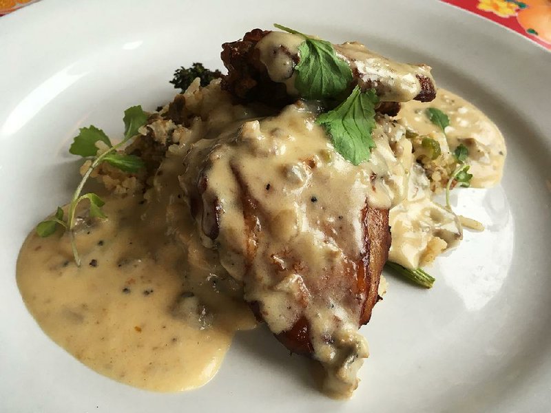 Roast chicken with dirty rice and andouille gravy is one of four dinner entrees at The Root Cafe in Little Rock’s South Main district. 