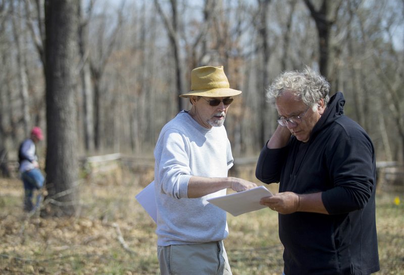 NWA Democrat-Gazette/JASON IVESTER Jami Lockhart (left) with the Arkansas Archeological Survey and Steven De Vore, archeologist with the National Park Service, look over maps of the area of the Leetown hamlet March 23 at the Pea Ridge Military National Park. Their work this spring sets the stage for a geophysical technology workshop for archeologists this week and a field school for University of Arkansas archeology students May 30 to June 30, both at the Leetown site.