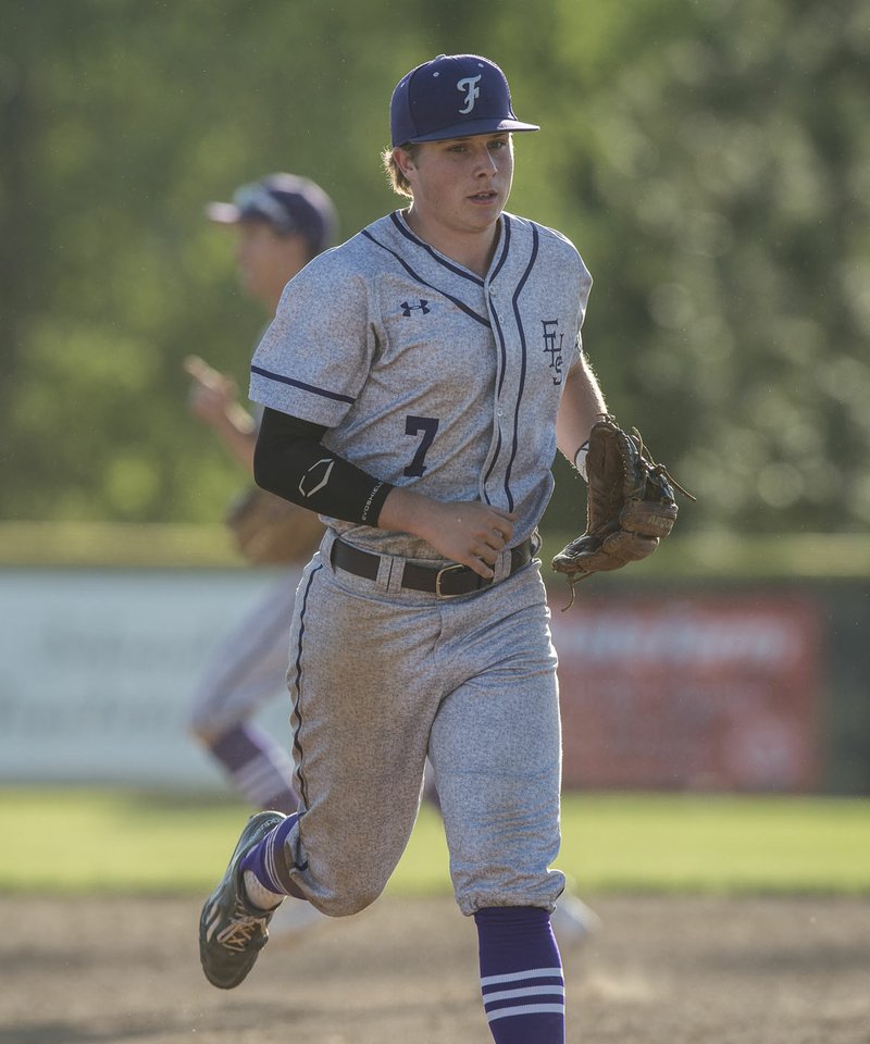 NWA Democrat-Gazette/ANTHONY REYES @NWATONYR Hayes Cox of Fayetteville jogs off the field April 24 after making the final out against Springdale at Bob Lyall Field in Springdale.