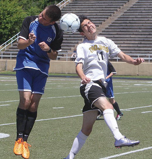 The Sentinel-Record/Richard Rasmussen HEADS-UP PLAY: Hot Springs' Tristan Trejo (11), right, and Greenbrier's John Evans head the ball during a Class 5A state-tournament game last May at Reese Memorial Stadium. Hot Springs won the match 6-1 and went on to beat Valley View in Fayetteville for the state championship. The Trojans begin their title defense today with a noon match against Pulaski Academy in Brookland (Craighead County).