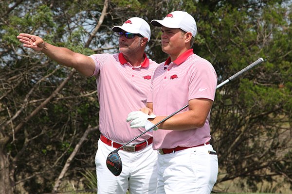 Arkansas' Mason Overstreet, right, talks with coach Brad McMakin during the SEC Championship at Sea Island Golf Club in St. Simons Island, Ga. 