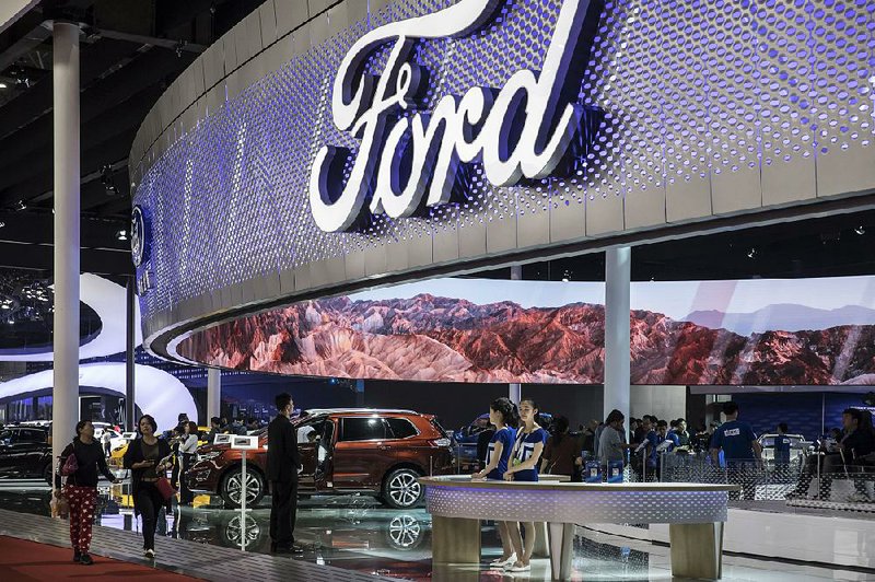 Visitors mingle in the Ford Motor Co. display area at the Auto Shanghai 2017 auto show in Shanghai in April. Ford conducted its annual meeting online this year, with 350 shareholders logging on for Thursday’s meeting.