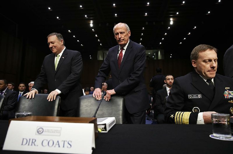 CIA Director Mike Pompeo (from left), Director of National Intelligence Dan Coats, and National Security Agency Director Adm. Michael Rogers prepare Thursday to testify before the Senate Intelligence Committee on threats facing the U.S.