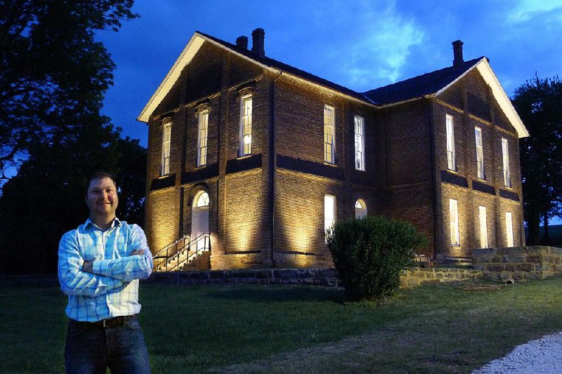 Bobby Braly, executive director of Historic Cane Hill Inc., stands outside the Cane Hill College building, which recently underwent a $1.4 million restoration that will be unveiled to the public Saturday.