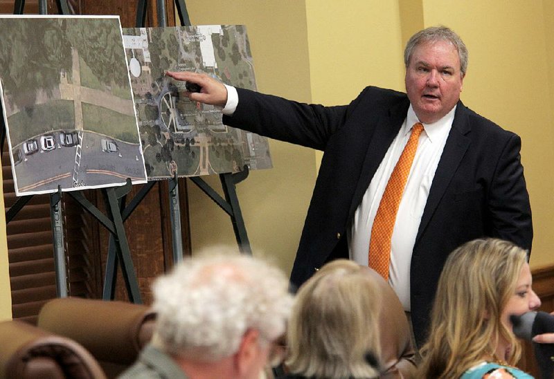During Thursday’s meeting at the Capitol, Kelly Boyd, chief deputy secretary of state, shows on aerial photographs the spot where the Ten Commandments monument will be placed. 