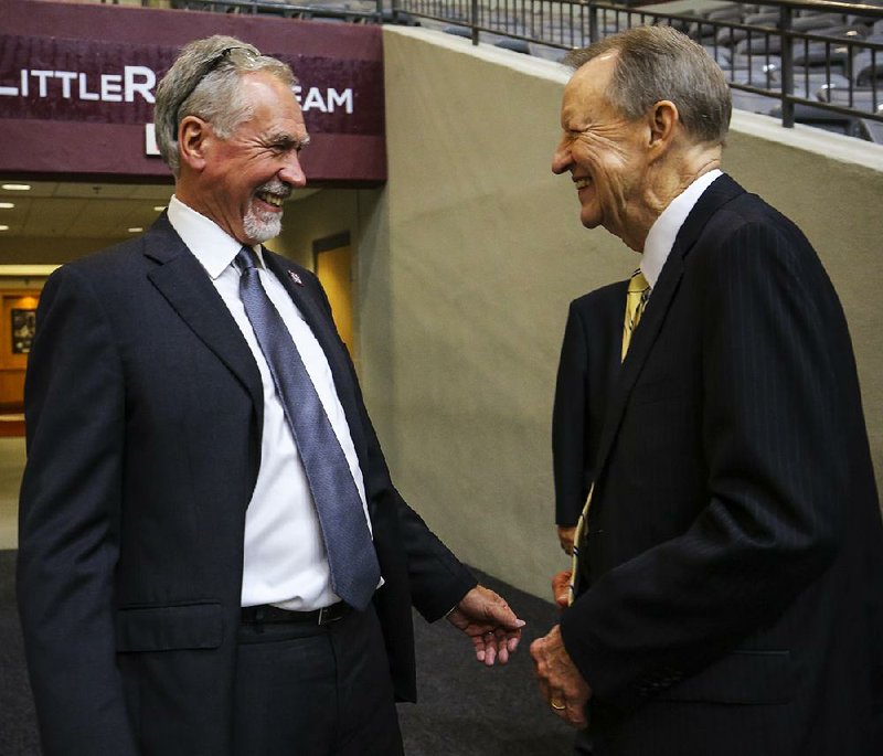 University of Arkansas at Little Rock Chancellor Andrew Rogerson (left) shares a laugh with former Chancellor Joel Anderson after Rogerson’s investiture ceremony Thursday on campus.