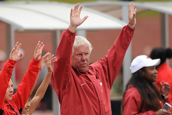 Arkansas coach Lance Harter call the Hogs Saturday, April 22, 2017, with winners of the Fastest Kid in Fayetteville competition during the John McDonnell Invitational at John McDonnell Field in Fayetteville.