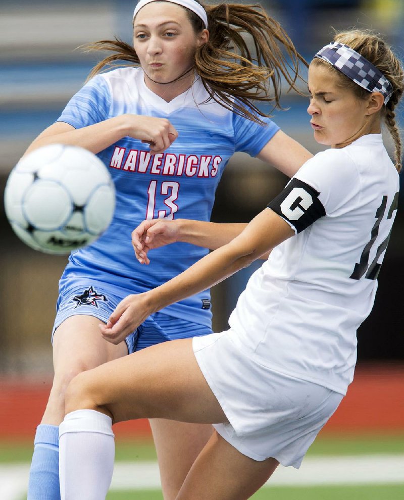 Southside’s Hannah Schmidt (left) and Bentonville’s Caila Hanus go for the ball during a 7A girls quarterfinal at Fort Smith Southside. Bentonville won 5-0.