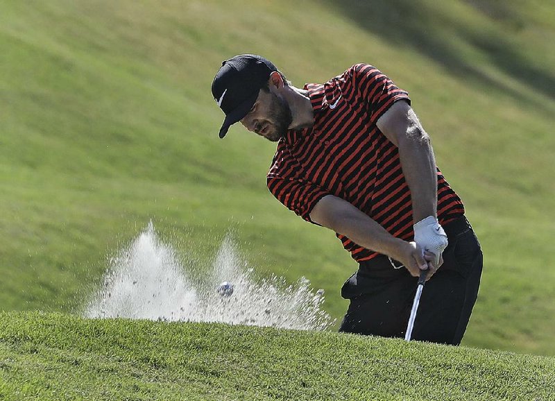 Kyle Stanley hits from the sand on the ÿfth hole in the second round of the Players Championship at Ponte Vedra, Fla. Stanley and Louis Oosthuizen have a two-shot lead after both shot a 6-under 66 Friday.