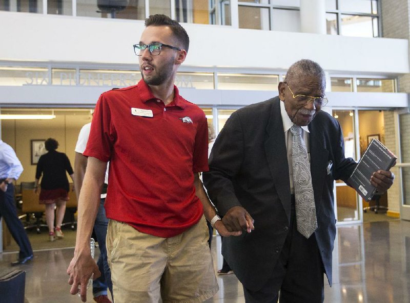 L. Clifford Davis (right) tours the University of Arkansas School of Law on Thursday with Weston Grant. 