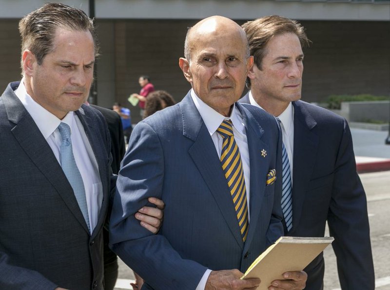  Former Los Angeles County Sheriff Lee Baca (center) walks with attorneys David Hochman (left) and Nathan Hochman after his sentencing Friday in Los Angeles. 
