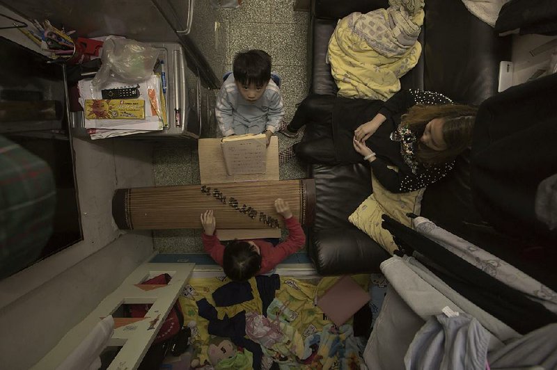 Li Suet-wen and her son and daughter live in a 120-square-foot room in an aging walkup in Hong Kong where she pays $580 a month in rent and utilities.  