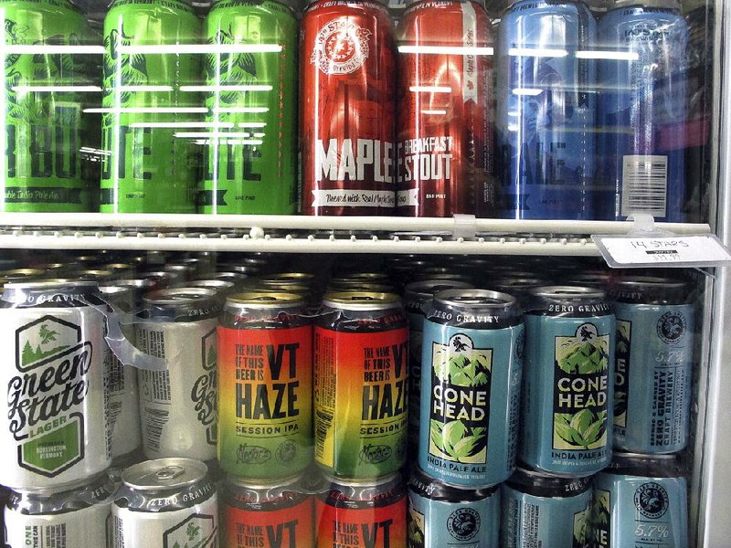 Different varieties of Vermont craft beer are displayed in a cooler at Mehuron’s Market earlier this month, in Waitsfield, Vt. 