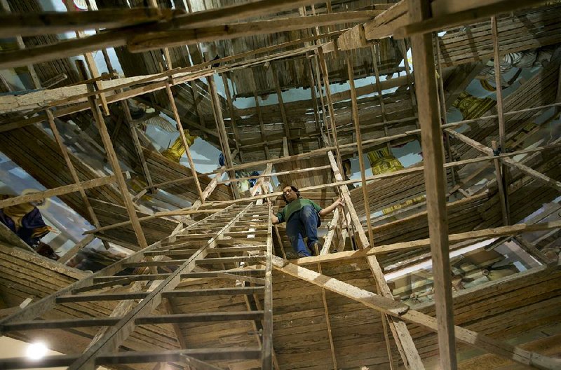 Climbing scaffolding, artist Ayman William moves from mural to mural within Mar Girgis Church in Cairo, which is building a new extension.