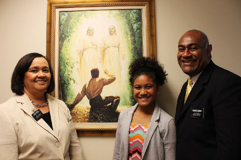 Mission President of Arkansas Taniela Wakolo (right) stands with his wife, Anita Wakolo, (left) and their daughter, Jasmin, at a state mission office. Taniela Wakolo has been called by the church to be a general authority seventy, 
a position held by fewer than 100 people in the church worldwide.