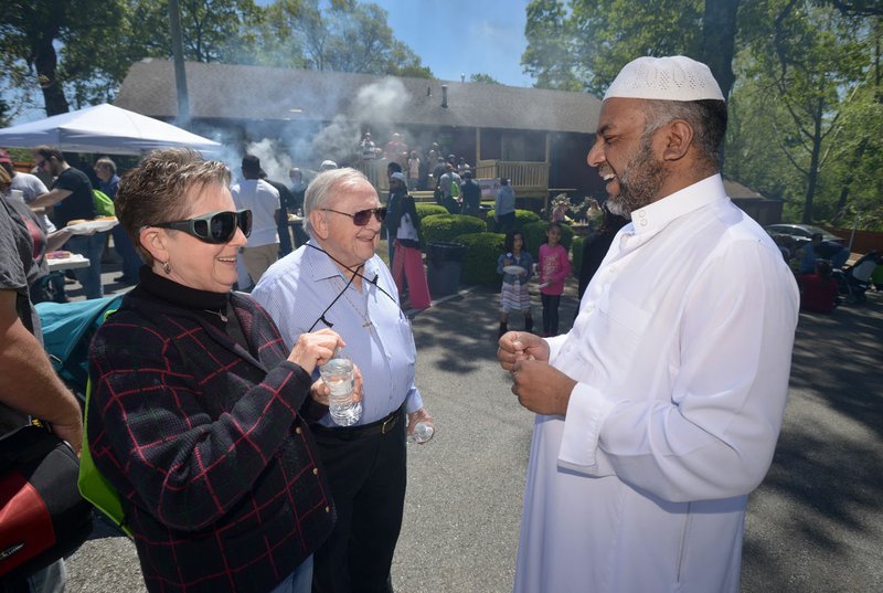 Ila Blackketter-Wolfe and husband the Rev. Darwin Wolfe, a retired Presbyterian minister, members of First Presbyterian Church of Bentonville, talk with Muhammed Khan, president of the Bentonville Islamic Center. Participants in the Abraham Peace Walk on April 23 ended the walk at an open house at the mosque. Members of Waterway Christian Church, First Christian Church of Bentonville, Congregation Etz Chaim and the Bentonville Islamic Center walked across town together from Waterway in a show of peace between Christianity, Judaism and Islam, which all trace their roots to the biblical patriarch Abraham.