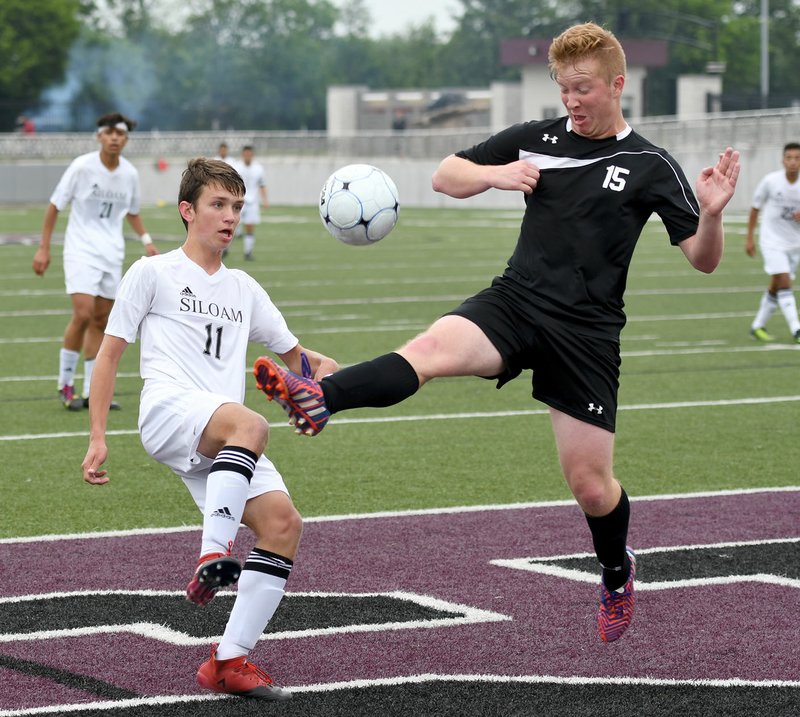 Siloam Springs sophomore Eli Jackson, left, goes against Searcy's Jessie Paslay on Friday in the 6A quarterfinals at Panther Stadium in Siloam Springs. The Panthers defeated the Lions 6-0.
