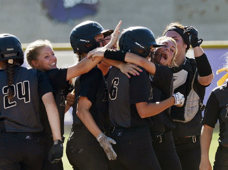 Bentonville players celebrate Saturday after defeating Cabot 10-0 in the semiÿnals of the Class 7A state tournament in Fayetteville, The Lady Tigers advanced to face North Little Rock in a rematch of last year’s state championship game. 