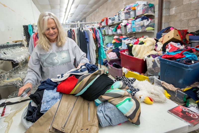 Jolene Cunningham of Bella Vista helps sort donations inside the Northwest Arkansas Women’s Shelter Thrift Store in Rogers. The store, which benefits the shelter, is open Monday through Saturday.