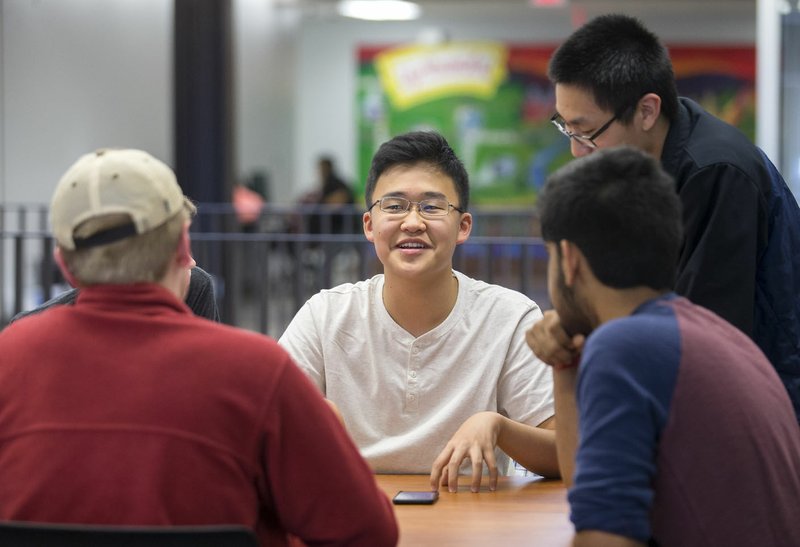 Fayetteville senior Ryan Kim talks with other members of the school's Science Bowl team May 4 at Fayetteville High School.