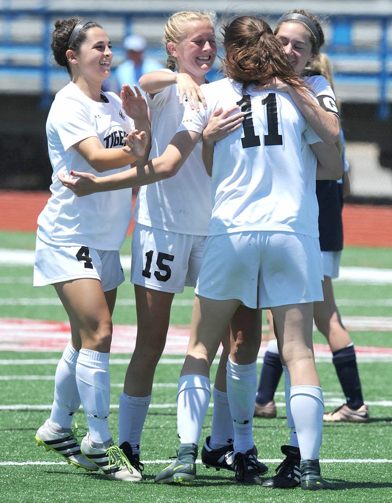 Bentonville High’s Tyler Anne Reash (from left), Sydney Suggs, Lauren Hargus and Emma Welch celebrate Saturday after Hargus scored against Springdale Har-Ber at Jim Rowland Stadium at Southside High School in Fort Smith. Visit nwadg.com/photos for more photographs from the match.