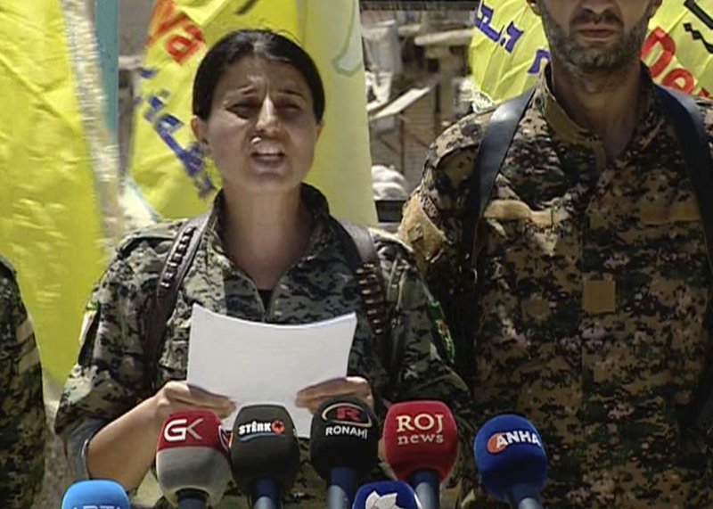 This frame grab from video provided by The Syrian Democratic Forces, a U.S.-backed Syrian Kurdish forces outlet that is consistent with independent AP reporting, shows Jihan Sheikh Ahmed, Spokeswoman for the Syrian Democratic Forces, reads a statement after they captured the Tabqa town from the Islamic State militants, in Tabqa town, north Syria, Friday May 12, 2017.