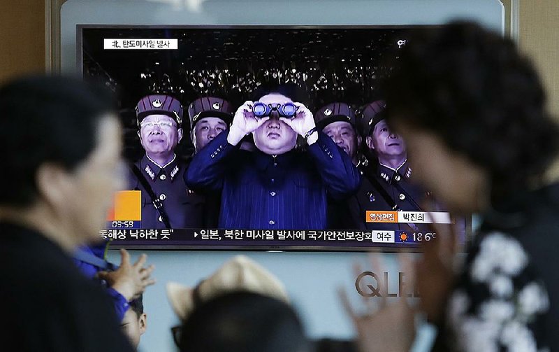 A television at the main railway station in Seoul, South Korea, shows video Sunday of North Korean leader Kim Jong Un after the launch of a missile that traveled more than 400 miles in a 30-minute flight.