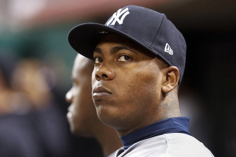 In this Monday, May 8, 2017, file photo, New York Yankees relief pitcher Aroldis Chapman sits in the dugout in the ninth inning of a baseball game against the Cincinnati Reds in Cincinnati. 