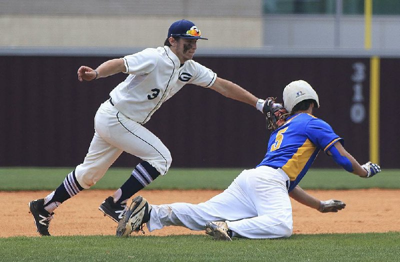 Greenwood shortstop Peyton Holt (left) runs down Sheridan base runner Justin Pruitt during the semifinals of the Class 6A state baseball tournament Monday. The Yellowjackets got a solid outing on the mound from Tyler Cleveland to hold off the Bulldogs 1-0 and advance to the state title game.