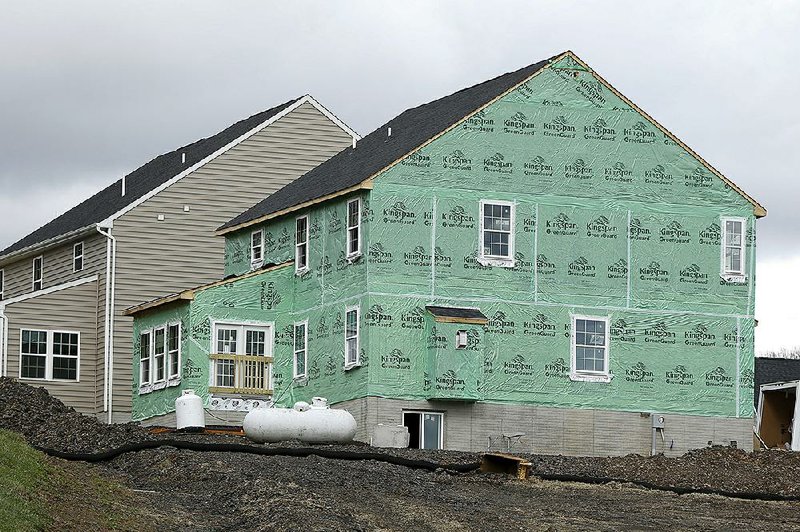 New home construction is underway in a housing development in Zelienople, Pa., in March.