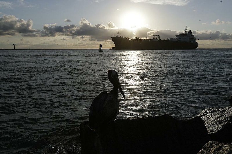 An oil tanker is steered though the channel in Port Aransas, Texas, on Monday.