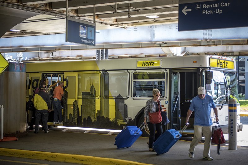 A Hertz Global Holdings shuttle bus picks up and drops off travelers at O'Hare International Airport in Chicago on Aug. 6, 2015. 