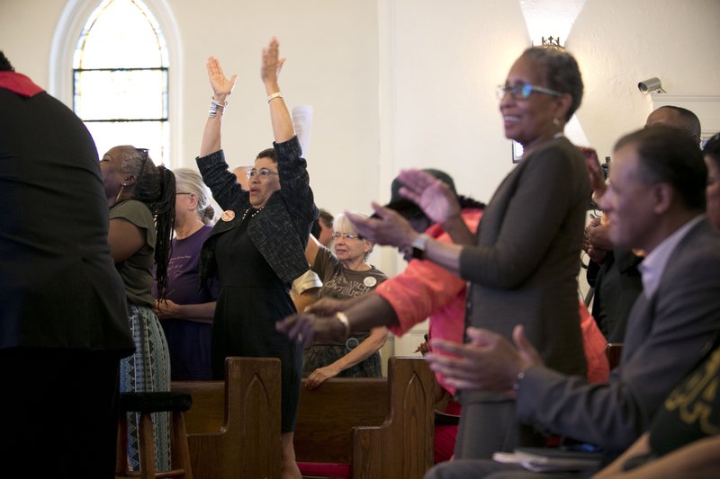 Those gathered for North Carolina NAACP president Rev. William J. Barber's announcement that he is stepping down as president of the civil right organization, break into celebration after learning that the US Supreme Court declined to consider reinstating North Carolina's 2013 elections law that included voter ID and other restrictions on voting at Davie Street Presbyterian Church in Raleigh, N.C. on Monday, May 15, 2017. 
