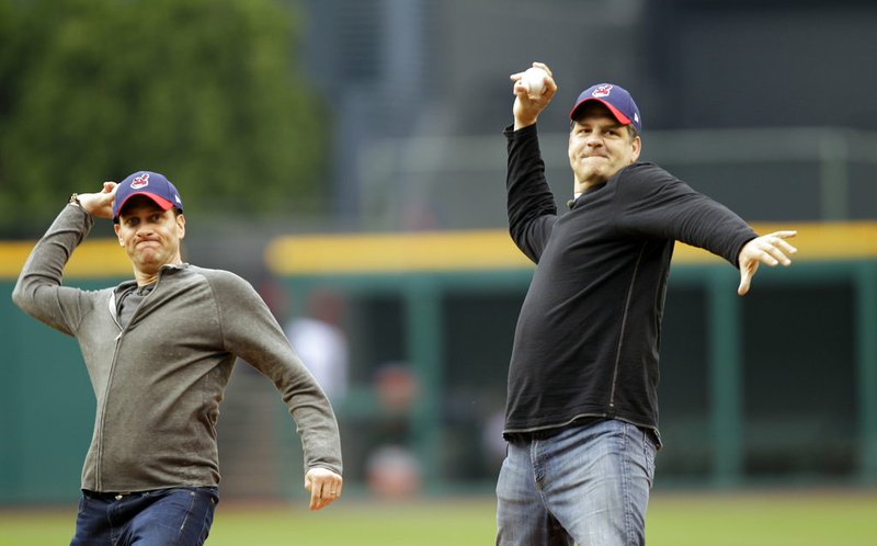 In this May 8, 2012, file photo, ESPN radio hosts Mike Greenberg, left, and Mike Golic throw out first pitches before a baseball game between the Cleveland Indians and the Chicago White Sox in Cleveland. 