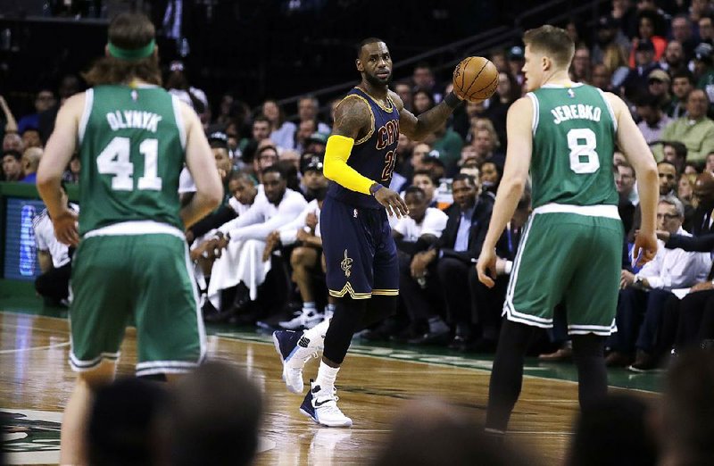 Cleveland forward LeBron James (center) is averaging 29 points and 8.8 rebounds in 29 career playoff games against Boston, which hosts Game 1 of the NBA Eastern Conference finals tonight. 