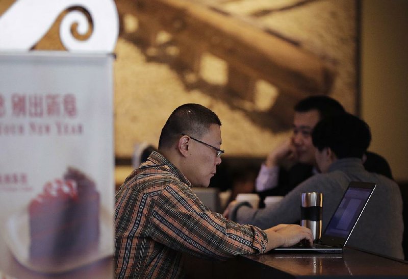 A man surfs the Internet on his laptop in a Beijing cafe. Security researchers say China’s fondness for pirated software left it especially vulnerable to the latest global cyberattack.
