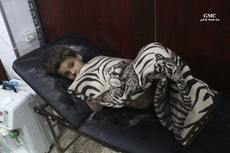  A boy who was wounded by Syrian rocket fire lies in a makeshift hospital Tuesday in an eastern suburb of Damascus. Syrian activists said government forces are escalating attacks on opposition-held areas despite a recently brokered cease-fire.
