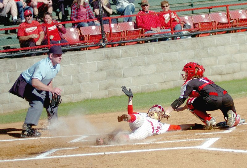 MARK HUMPHREY ENTERPRISE-LEADER Farmington freshman Kally Stout is shown tagged out at the home-plate while attempting to slide in by Maumelle catcher Reagan Pierce on May 1. Farmington lost 2-1 to Paragould to exit from the 5A State softball tournament Thursday.