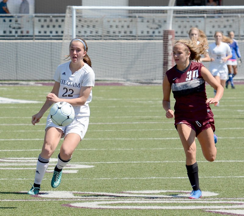 Bud Sullins/Special to the Herald-Leader Siloam Springs junior Audrey Maxwell, left, takes a touch during the Class 6A state semifinals against Benton on Saturday at Panther Stadium.