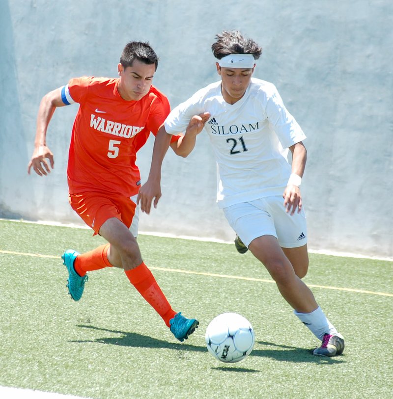 Graham Thomas/Herald-Leader Siloam Springs sophomore Christian Marroquin, right, runs by Little Rock Hall defender Dilan Veloso during the Class 6A state semifinals on Saturday at Panther Stadium. Marroquin scored the Panthers&#8217; only goal in regulation and also had a score in the penalty kicks period as Siloam Springs defeated Hall 1-1 (3-1 PKs) to advance to the state championship match. Marroquin leads the Panthers with 19 goals and 11 assists.