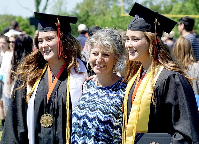 Photo by Randy Moll The Krewson twins, Alex and Abbi, posed for a photo with their mother following graduation ceremonies on Saturday.
