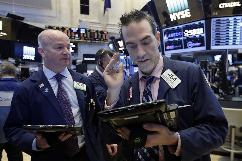 Traders Patrick Casey, left, and Gregory Rowe work on the floor of the New York Stock Exchange, Tuesday, May 16, 2017. U.S. stock indexes were little changed in early trading Tuesday, a day after the market closed at record highs. (AP Photo/Richard Drew)