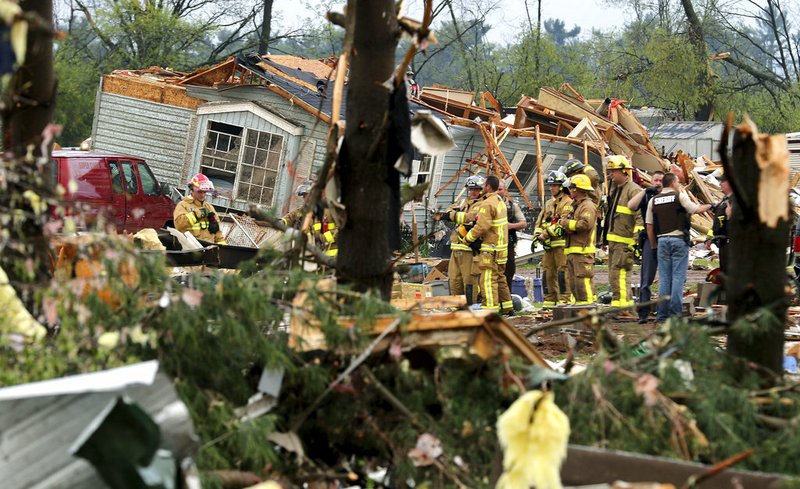 Firefighters work the site of the damage after a tornado ripped through Prairie Lake Estates trailer home park, just north of Chetek, Wis., on Tuesday, May 16, 2017. 