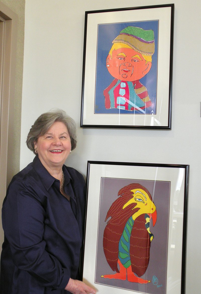 J.D. “Judith” Beale of Jacksonville shows a sampling of her digital drawings that are on display at First Security Bank in Clinton. The exhibit, Children’s Character Tales, Series 1, will remain on display until June 30.