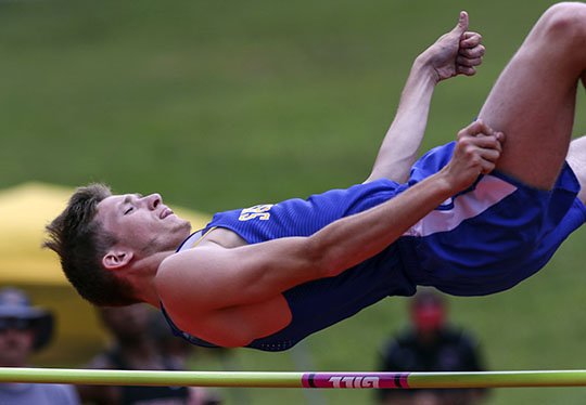 Arkansas Democrat-Gazette/Mitchell Pe Masilun MULTI-TASKING ATHLETES: Sheridan’s Michael Burnett competes in the high jump during the Arkansas high school decathlon Wednesday at Cabot High School. Gosnell’s Marquel McKinney led after the first five events while Clinton’s Annie Hensley led after four events of the high school heptathlon, both events ending today.